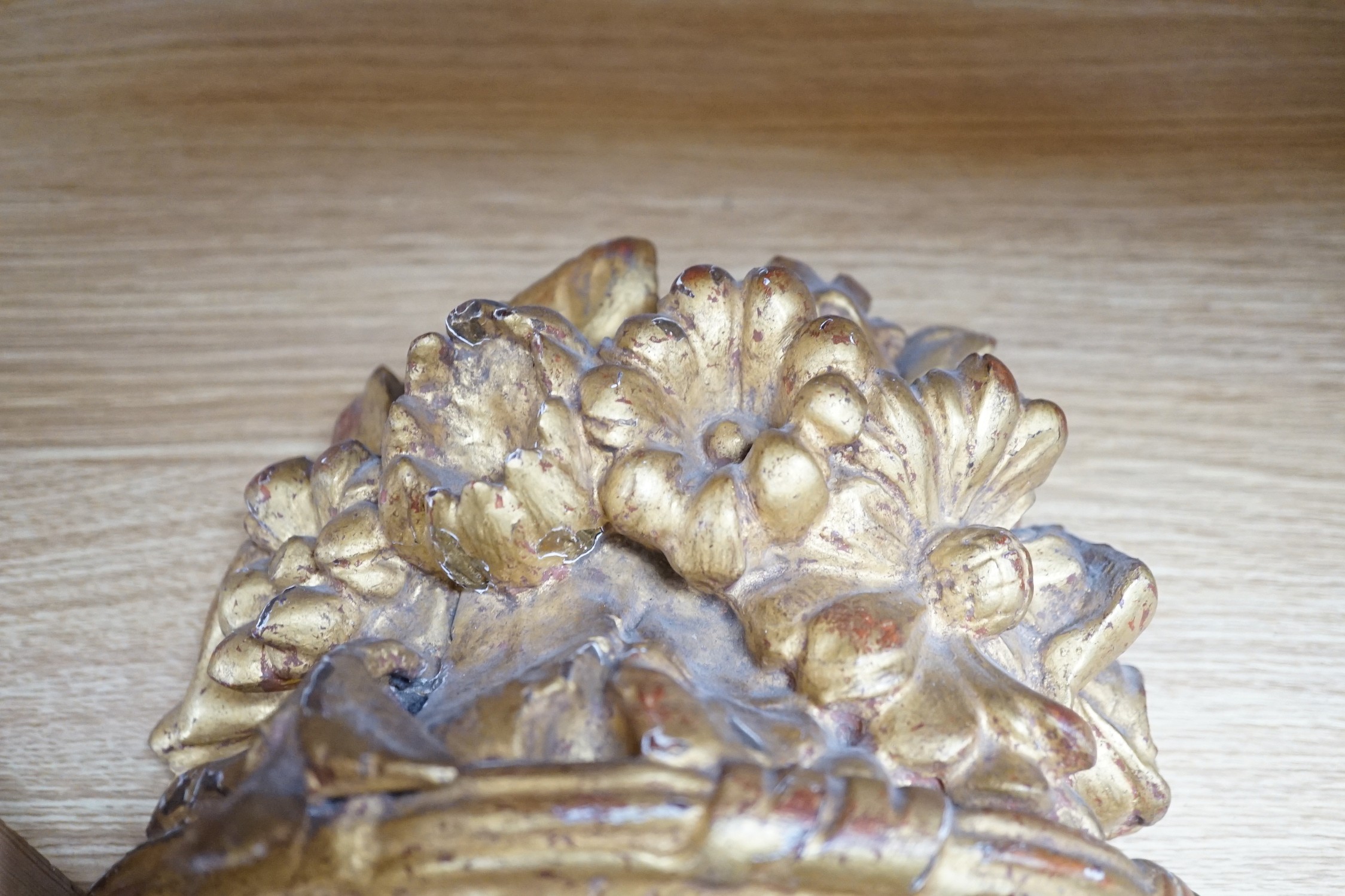 A pair of carved giltwood basket wall sconces, 29cms high